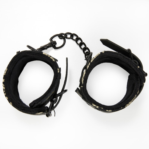 An overhead view of the soft-lined Bonds of Desire wrist restraints from above on a white surface